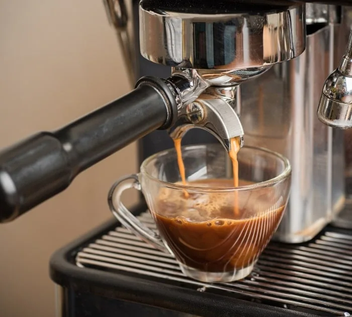 A coffee machine dispensing a coffee